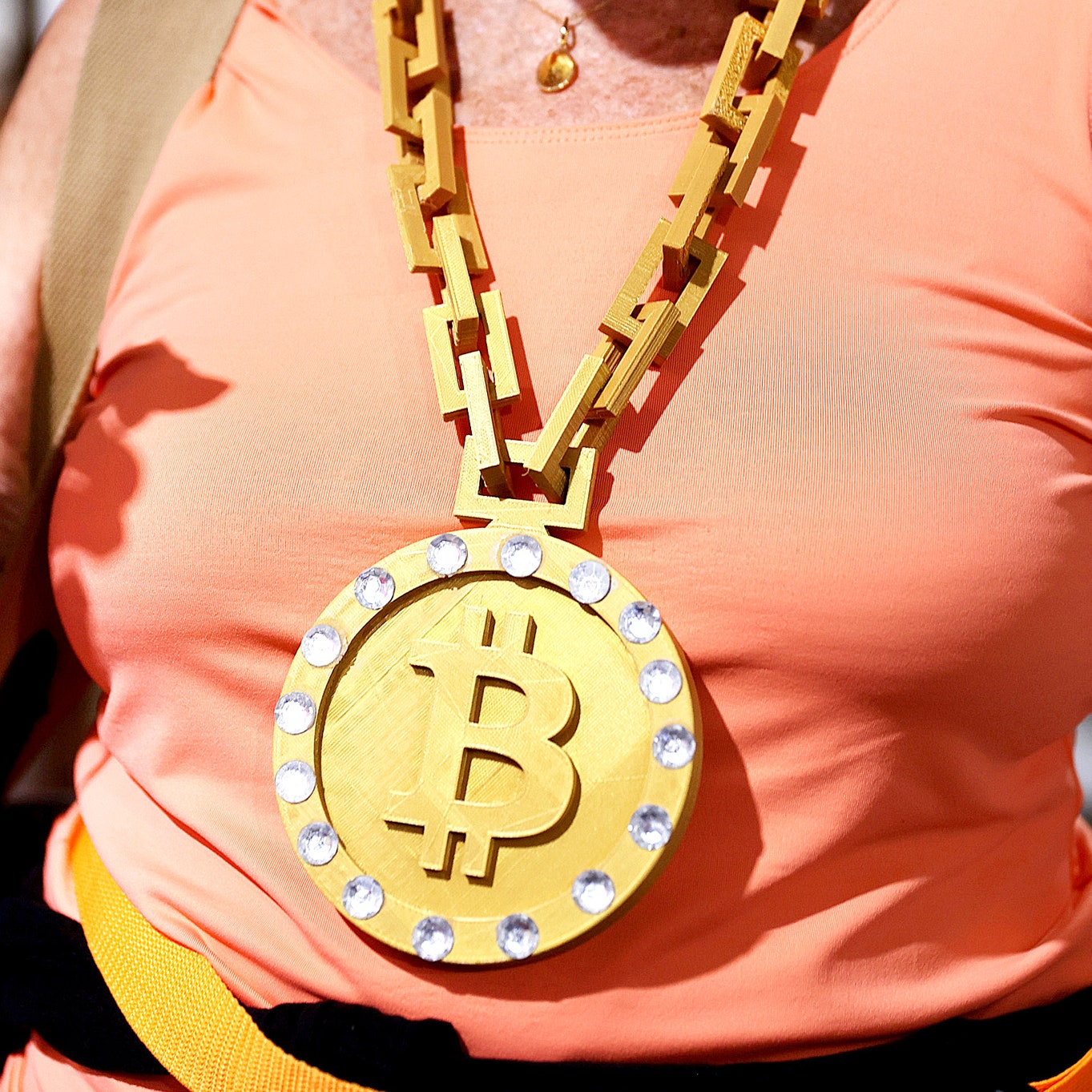 An attendee wears a necklace at the Bitcoin 2021 Convention